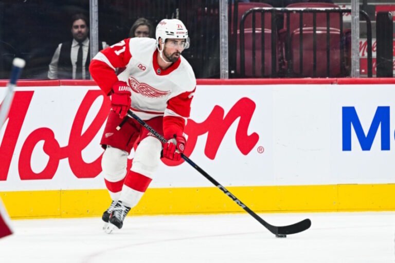 Simon Edvinsson, Dylan Larkin, and Alexander Nikishin